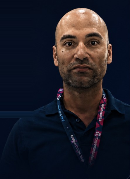Amir, a Shield customer, wearing a trade-show lanyard.